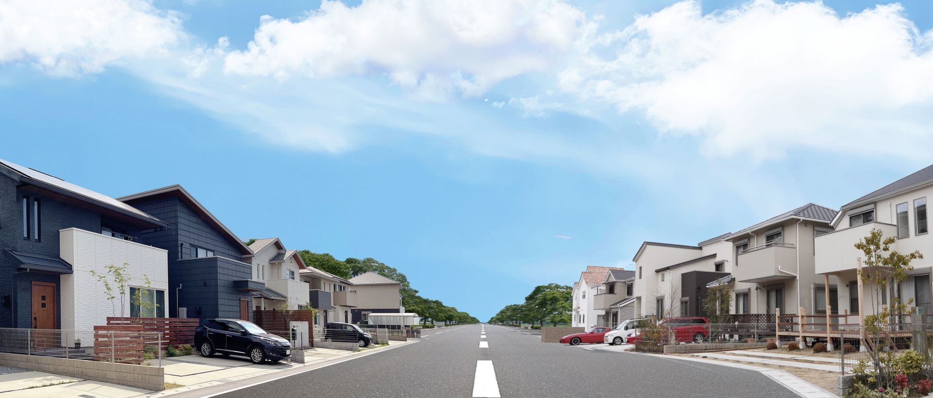 広がる青空と住宅街の道路のイメージ